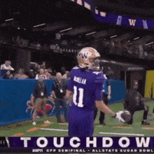 a football player in a purple uniform with the number 11 on the back