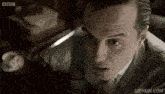 a close up of a man 's face with a bbc logo in the corner