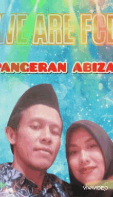 a man and a woman are posing for a picture in front of a sign that says we are for