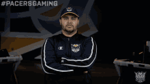 a man with his arms crossed wears a pacers gaming jacket