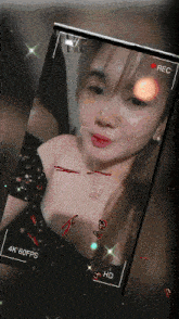 a woman 's face is being recorded on a cell phone screen