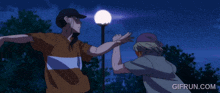 a gif from gifrun.com shows two people dancing in front of a street light