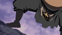a person wearing a black shirt and a belt with a gold star on it