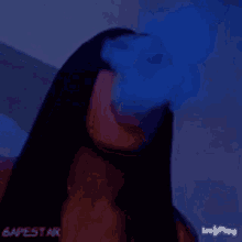 a woman with long black hair is smoking a cigarette and smoke is coming out of her mouth .