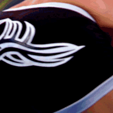 a close up of a person wearing black shorts with a white logo