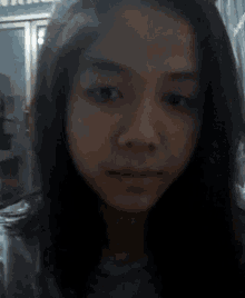 a close up of a young woman 's face with a blurred background