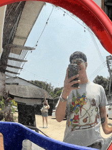 a man is taking a picture of himself in the mirror