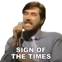 a man speaking into a microphone with the words " sign of the times " written below him
