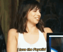 a woman says i love the feywild in front of a computer