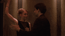 a man and a woman are standing next to each other