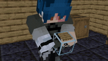 a person in a minecraft game holding a cube in their hand