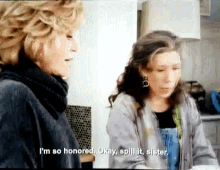 two women are standing next to each other and one of them is saying i 'm so honored okay spill it sister .