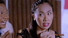 a man and a woman in a man laksa video