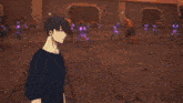 a man in a black shirt is standing in front of a wall with candles on it