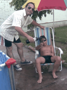 a man is pouring a bottle of wine into a boy in a chair