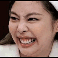 a woman is making a funny face with her mouth open .