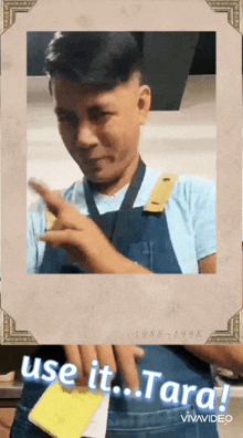 a man wearing a blue apron is holding a piece of paper that says use it tara