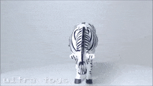 a black and white zebra toy with the words ultra toys written on the bottom