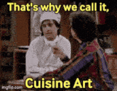 a man in a chef 's hat is talking to a man in a plaid shirt in a kitchen .