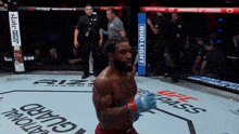 a man in a boxing ring with a bud light sign on the side