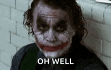a close up of the joker 's face with the words `` oh well '' .