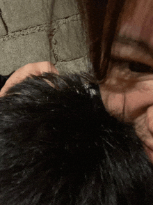 a close up of a person 's hair with a gray background