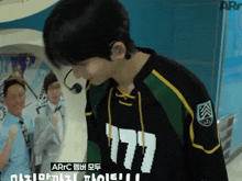 a man wearing a black and green shirt that says arfc