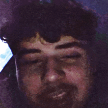 a close up of a man 's face with a blurry background