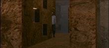 a man in a white shirt is walking down a hallway with the number 2770 on the walls