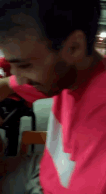 a man wearing a pink shirt with the word nike on the sleeve