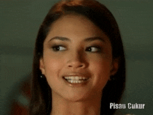 a close up of a woman 's face with the words pisau ukur below it