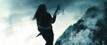 a man with long hair is playing an electric guitar