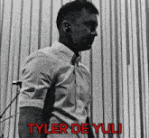 a black and white photo of a man with the name tyler de yuli