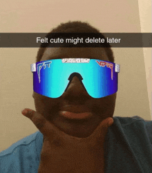 a man wearing a pair of blue viper sunglasses holds his hand to his chin