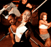 a woman in a black and white dress is dancing with two other women