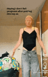 a man is wearing a black tank top and jeans with the caption hoping i do n't fall pregnant
