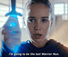 a close up of a woman holding a sword with the words i 'm going to be the last warrior nun