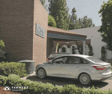 a car parked in front of a farmers insurance building