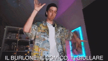 a man in a colorful shirt is dancing in a room with a purple background .