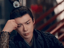 a man with a crown on his head is looking at the camera