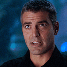 a close up of a man 's face with a black shirt on