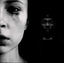 a black and white photo of a woman crying and a man