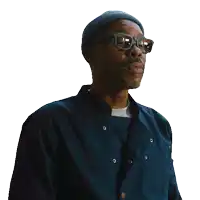 a man wearing glasses and a beanie says " who "