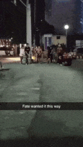 a group of people standing on a street with the words fate wanted it this way on the bottom