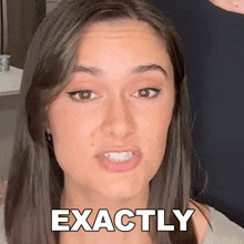 a close up of a woman 's face with the word exactly above her mouth