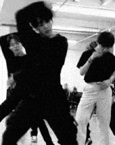 a group of young men are dancing together in a room .