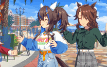 a girl with a ponytail is standing next to another girl with a ponytail