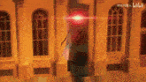a blurry picture of a building with a red light coming out of the top