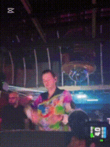 a blurred image of a man playing a drum set with the number 40 on it