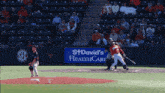 a baseball game is being played in front of a sign for st. david 's healthcare